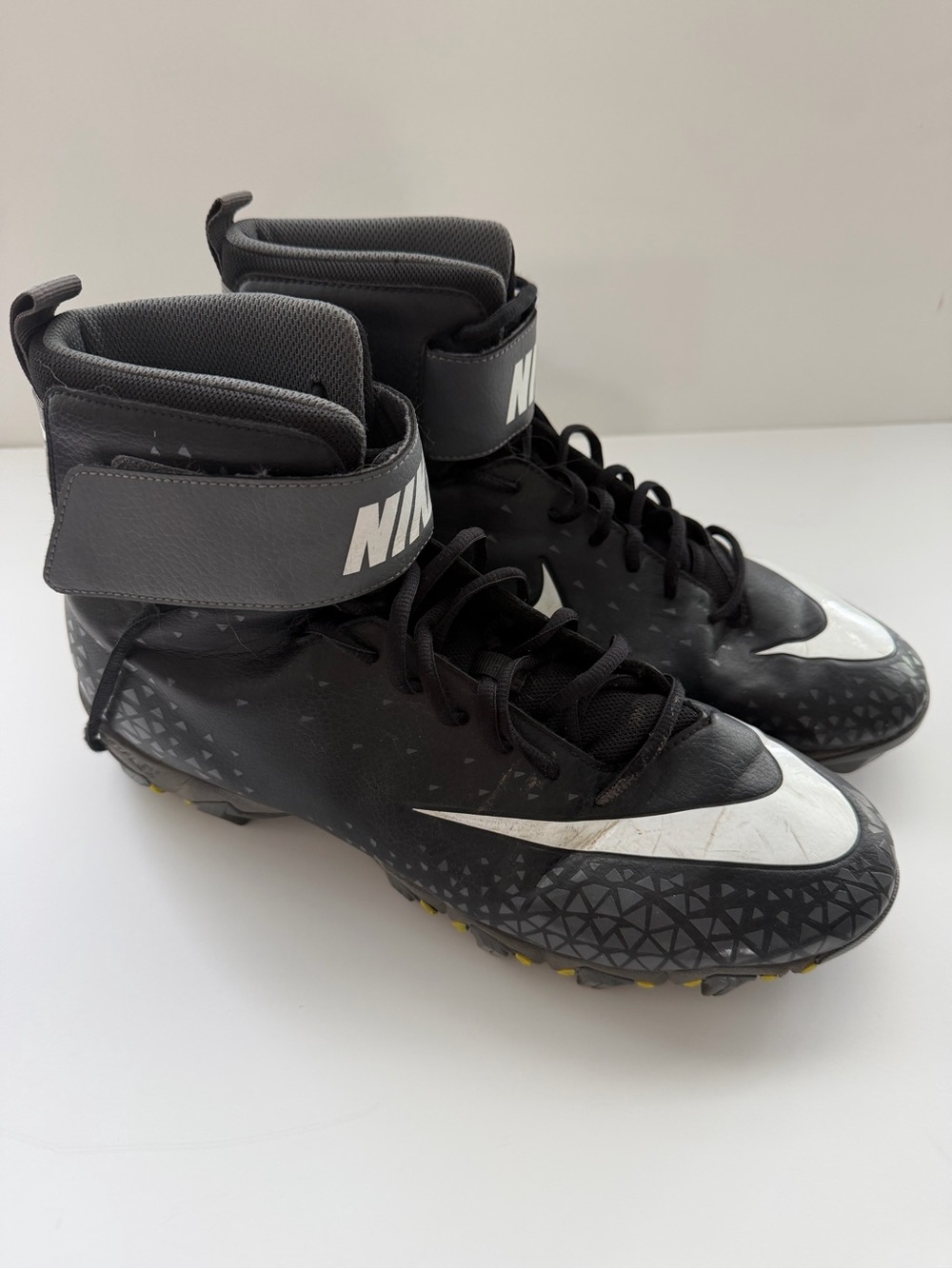 Nike Black and Gray High-Top Football Cleats with White Swoosh